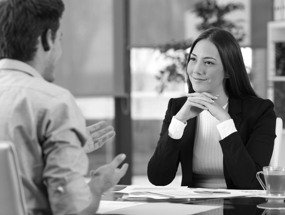 Businesswoman attending listening to a client who is talking at office